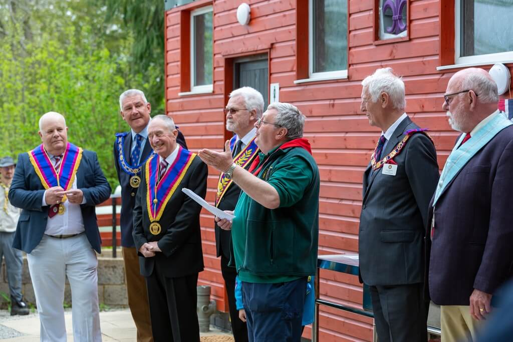 Picture of the Scout leader taking to the visitors during the opening ceremony of the new refurbished toilet block.