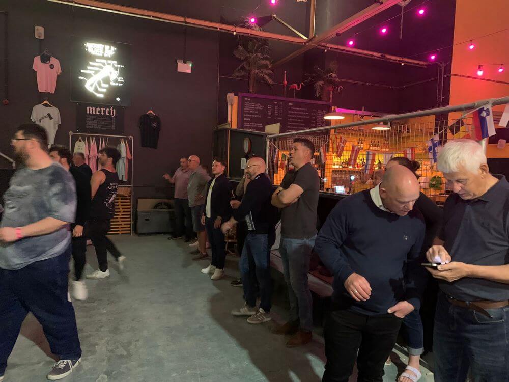 Waiting your turn Members of the lodge take their turn at throwing the axe, whilst others check the latest news on their phones!