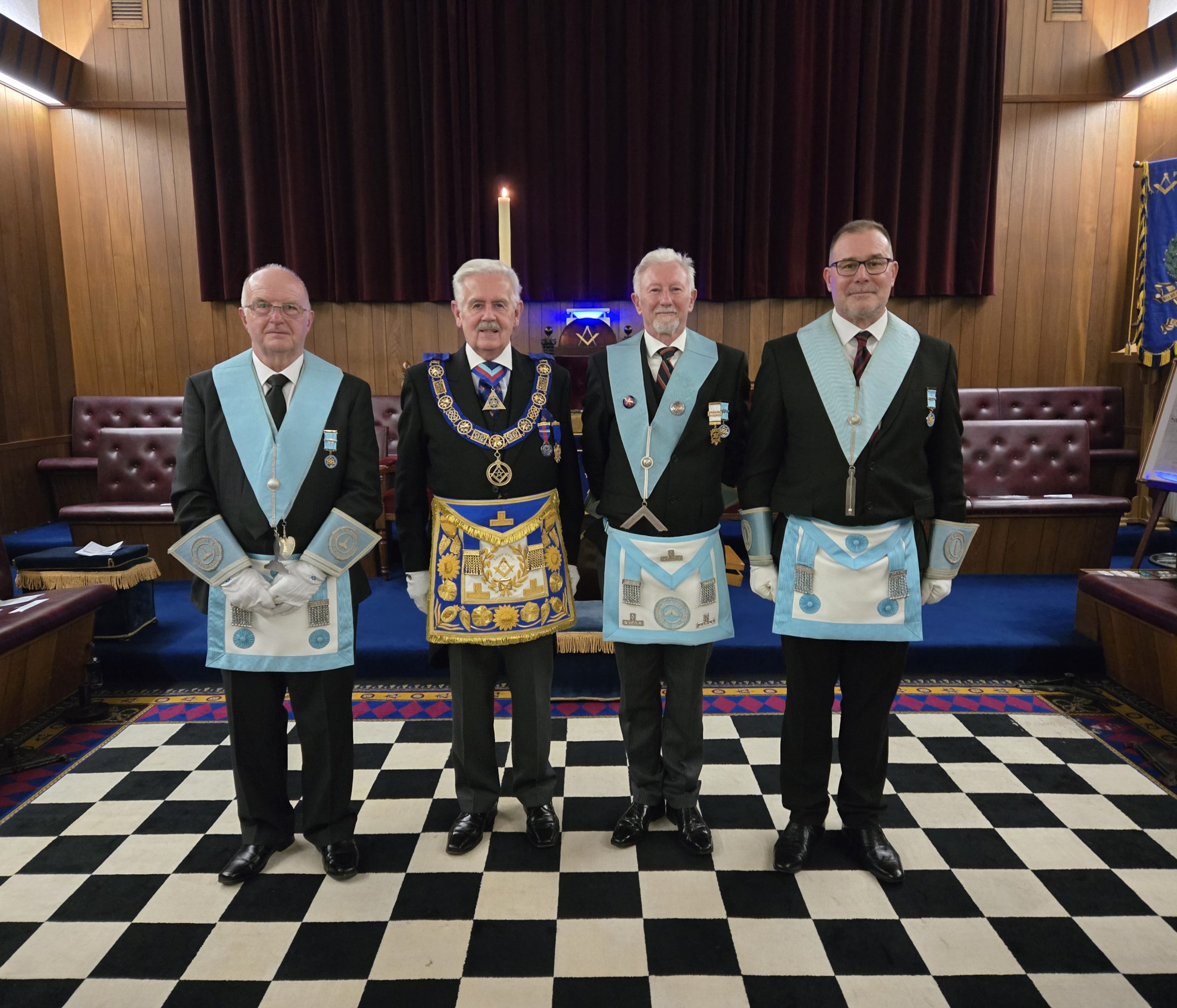 The Provincial Grand Master, stands with the Worshipful Master, Derek Lindars, and his two Warden (Outer)